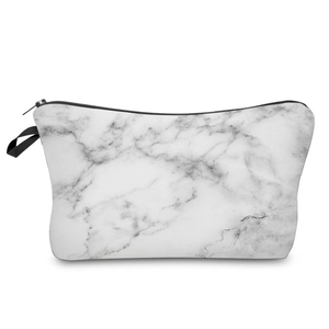 Macro shot of white marble pattern makeup bag with black zipper and side handle strap
