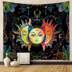 Bohemian sun and moon tapestry with celestial tarot patterns hanging on a bedroom wall