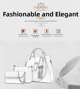 Detailed view of white embossed leather handbag set with tassels and gold hardware
