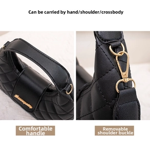 Detail of black quilted leather handbag with gold hardware and detachable shoulder strap