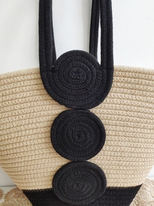 Handwoven cotton rope beach tote bag with black circular pattern and top handles