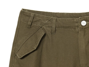 Close-up of military green cargo pants waist showing metal button and durable pocket seams