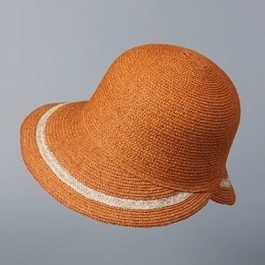 Close-up of woven straw sun hat texture and elegant decorative band detail