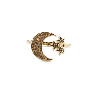 Detail of gold moon and star adjustable ring with shimmering cubic zirconia inlay