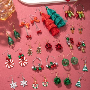 Various Christmas earrings with tree, reindeer, and snowflake charms in festive colors