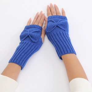 Detail of navy blue ribbed knit fingerless gloves featuring a decorative bow accent