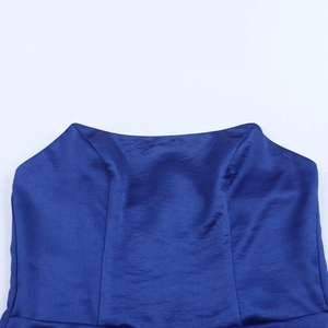 Detailed macro view of the blue satin fabric and neckline stitching on this formal dress