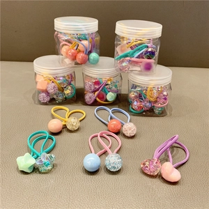 Assorted macaron colored elastic hair bands with heart and star shapes in a storage jar