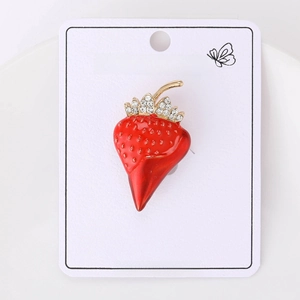 Close-up of red enamel strawberry brooch with sparkling rhinestones and gold finish