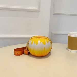Close-up of the yellow-white gradient round bag with a wide orange patterned strap