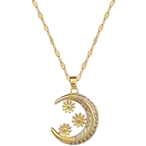 Elegant gold crescent moon necklace with rhinestones and floral details on white backdrop