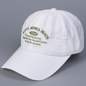 Close-up of white quick-dry nylon baseball cap with green Santa Monica Beach embroidery