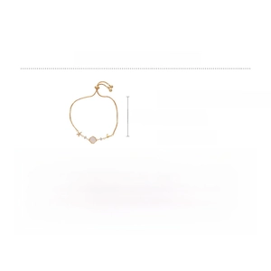 Detailed view of adjustable golden bracelet with zircon and mother of pearl charms