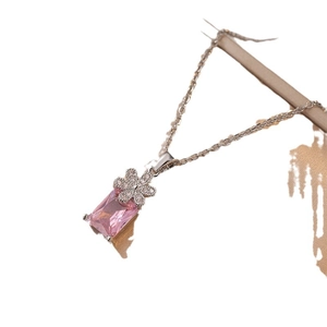 Elegant stainless steel necklace featuring a pink rectangular gemstone and floral pendant