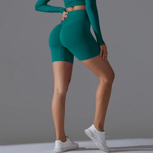 Detail showing high waist seamless lifting shorts and long sleeve crop top in dark teal