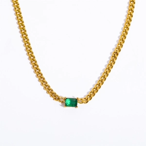 Detail of Cuban chain necklace featuring a rectangular green emerald gemstone setting