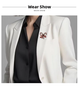 Close-up of a Christmas candy cane brooch with red bow on a white suit lapel
