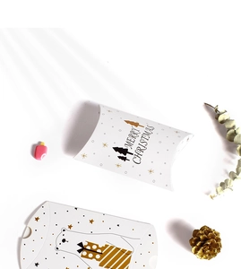 Detailed view of white Christmas pillow gift boxes with bear and pine tree patterns