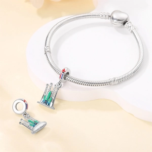 Detail of silver snake chain bracelet with Sagrada Familia colorful enamel pendant