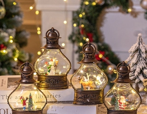 Close-up of vintage bronze Christmas lanterns with LED lights and holiday miniatures