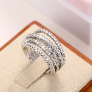 Macro shot of multi-layer intertwined ring featuring pave-set zircons on a jewelry box