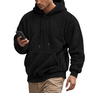 Detail of men's black hooded sweatshirt showing thick jacquard teddy fleece texture