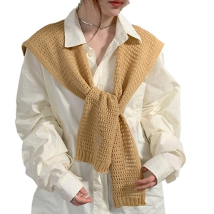 Knitted hollow-out shawl in camel brown color styled over a white shirt