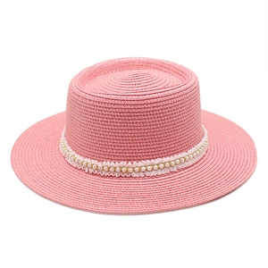 Pink flat-top straw hat with elegant lace trim and white pearls for sun protection