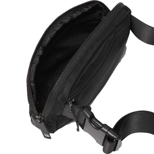 Detail of waterproof nylon waist bag showing interior mesh compartment and strap
