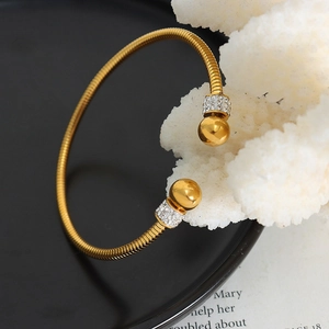 Elegant gold-plated coil bracelet with polished beads and sparkling rhinestone accents