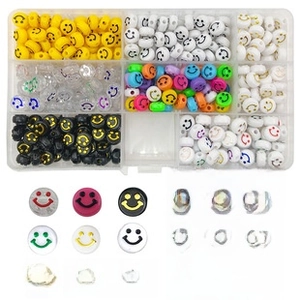 DIY bead kit with 7 styles of smiley face beads in an organizer with elastic crystal cord