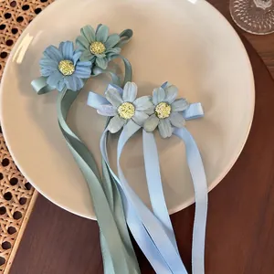 Floral daisy hair clips with long satin ribbons in green and blue for women
