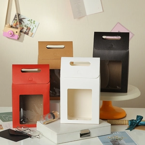 Minimalist paper gift boxes with window and handle in red, kraft, white, and black colors