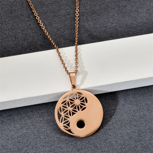 Detailed macro view of rose gold hollow Tai Chi pendant with intricate filigree texture