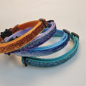 Set of four glittering nylon pet collars in orange purple blue and teal with buckles