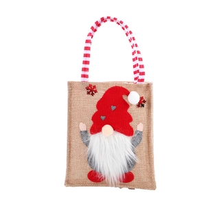 Christmas burlap gift bag with a 3D gnome design and festive red-white striped handles