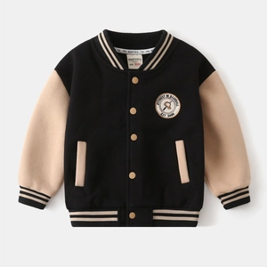Detail of boys' baseball jacket featuring embroidered patch and striped ribbed collar