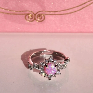 Pink opal flower ring with cubic zirconia halo and adjustable silver band on pink gift box