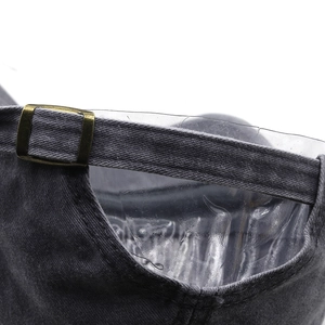 Detail of adjustable brass buckle and charcoal washed denim texture on baseball cap