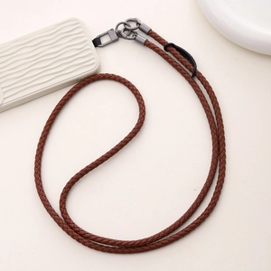 Macro shot of durable brown braided PU leather phone lanyard with dark grey metal clasps