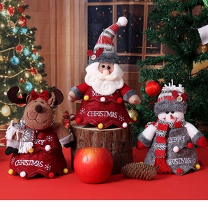 Detail of Christmas plush figurines featuring Santa, reindeer, and snowman in festive decor