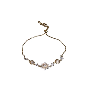 Elegant gold snowflake bracelet with white zircons and adjustable drawstring closure