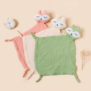 Three-pack of baby muslin fox head comforters in pink, beige, and green soft cotton