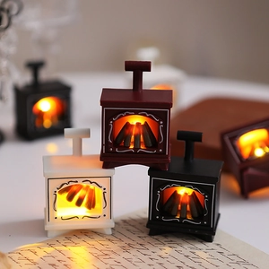 Close-up of vintage mini LED fireplaces in black, white and red with warm glowing wood