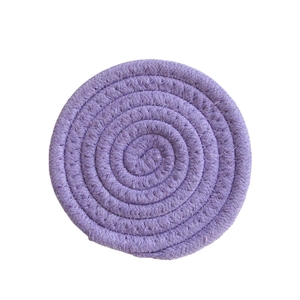 Detailed close-up of a handmade purple cotton woven round coaster with braided texture