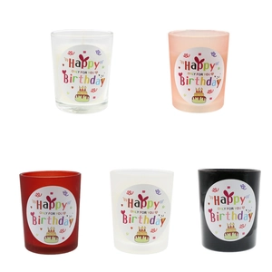 Five colorful Happy Birthday scented candles in glass jars for party gifts and favors