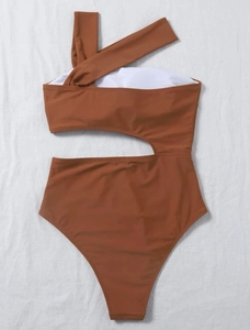 Detail shot of a one-shoulder brown swimsuit with a stylish cutout and elastic fabric