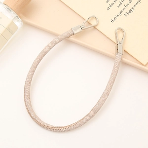 Close-up of beige woven wrist strap featuring polished silver dual lobster clasps