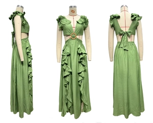 Detail view of green maxi dress featuring deep V-neck with ring and side cut-outs