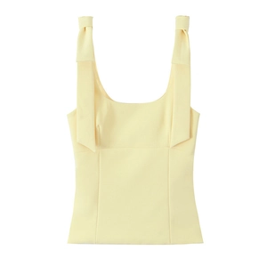 Slim fit light yellow tank top with stylish bow shoulder straps laid flat on white background